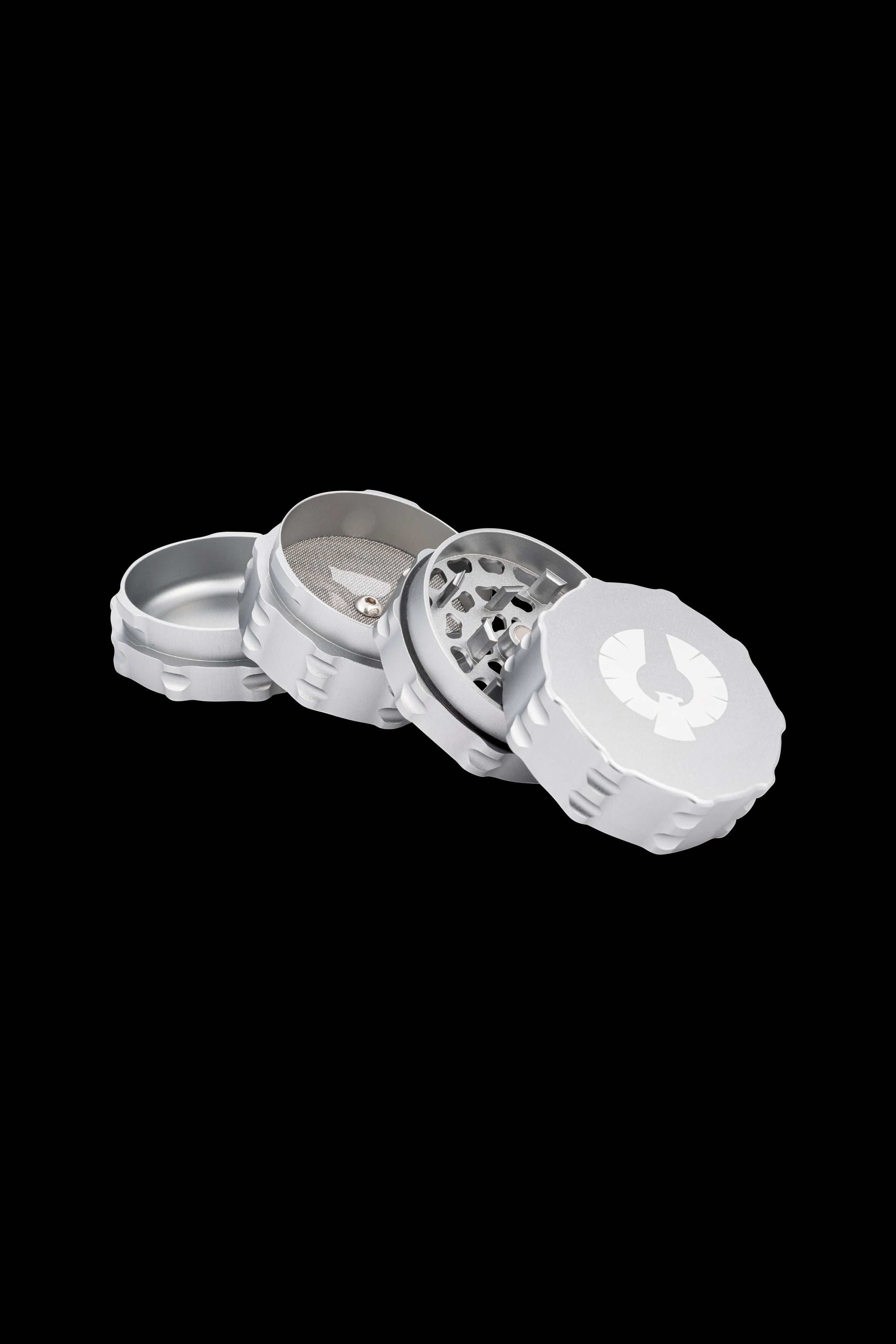 Silver four-piece cannabis grinder with disassembled parts floating in mid-air.
