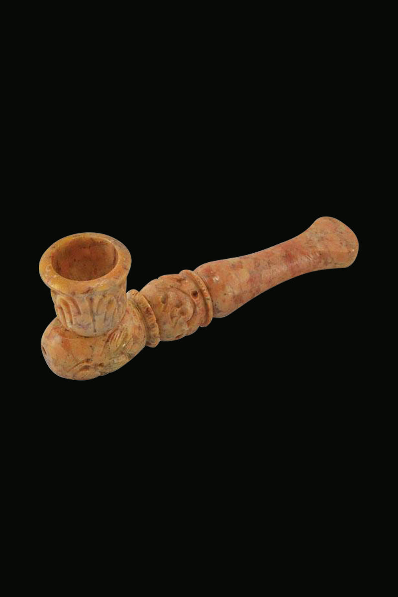 A side view of the Carved Marble Stone Pipe showing its detailed stone texture and curved design.