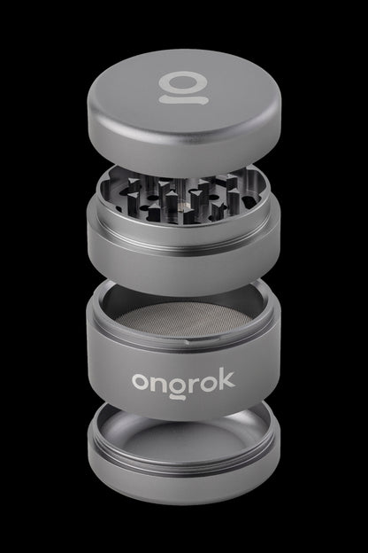 Silver four-piece cannabis grinder with “onrok” logo, disassembled to show internal components.