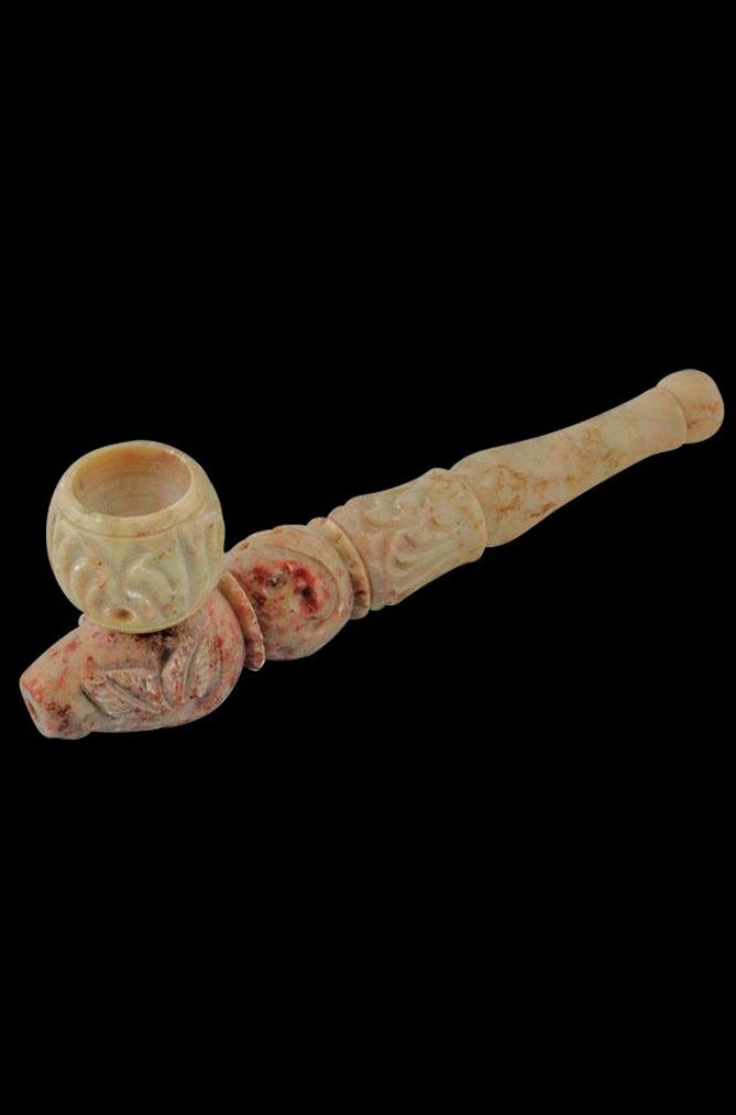 A detailed side view of the Carved Marble Stone Pipe, displaying its textured, stone surface and organic shape.