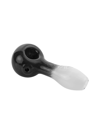 A close-up, angled view of the GRAV® Frit Spoon, showcasing its smooth, dark glass construction.