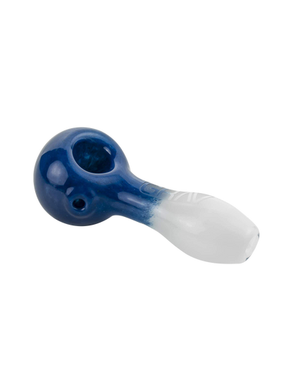 A close-up, angled view of the GRAV® Frit Spoon, showing its dark blue glass and curved design.