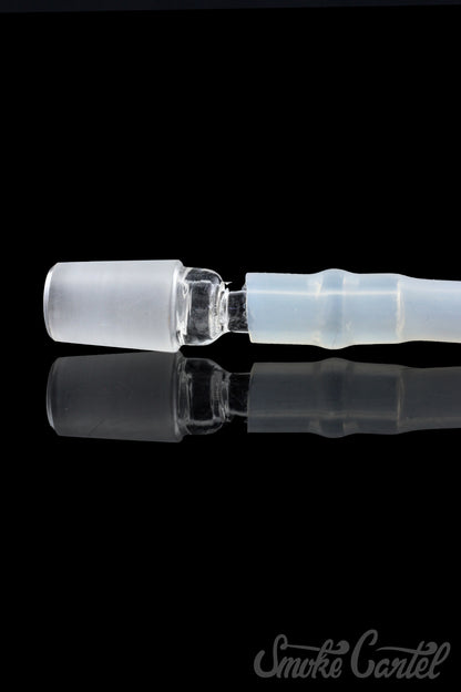 A close-up view of the clear glass Dip Devices DipWhip Attachment, reflecting light on its smooth, curved surface.