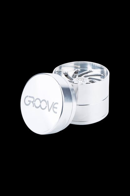 Silver cannabis grinder with “GROOVE” etched on the lid.