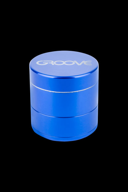 Blue four-piece cannabis grinder with "GROOVE" etched on the lid.