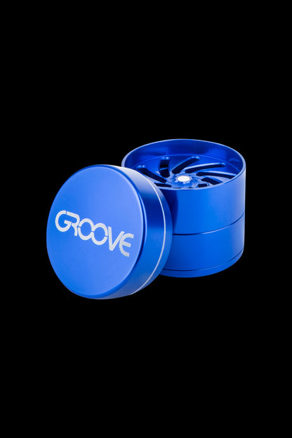 Blue four-piece cannabis grinder with “GROOVE” logo.