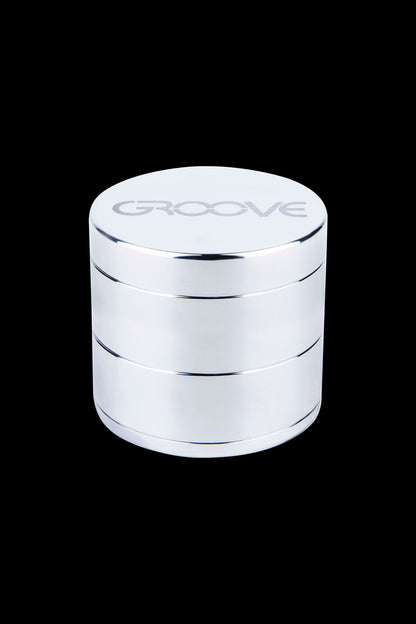 Silver four-layer cannabis grinder with “GROOVE” etched on top.