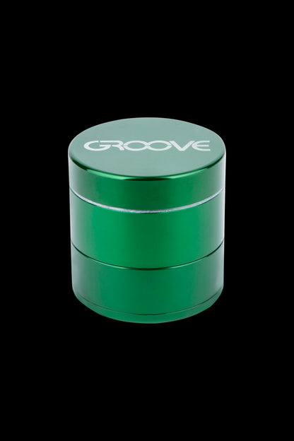 Green four-piece cannabis grinder with “GROOVE” logo.