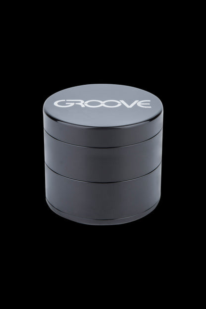 Black four-layer cannabis grinder with “GROOVE” logo on the lid.