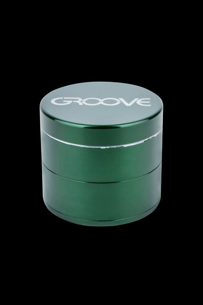 Green four-piece cannabis grinder with "GROOVE" logo.