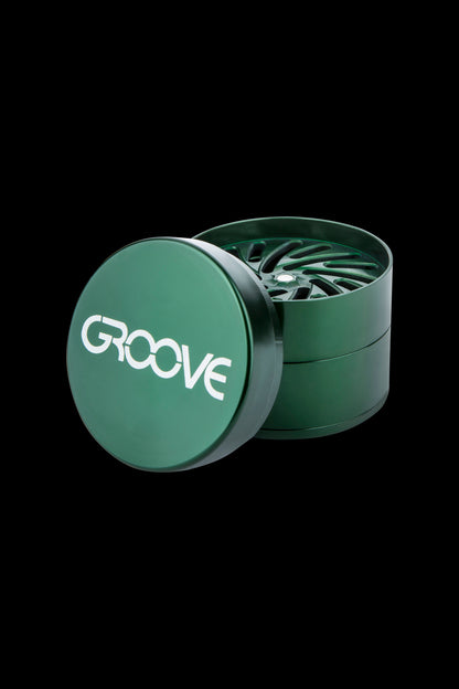 Green four-piece cannabis grinder with “GROOVE” logo.