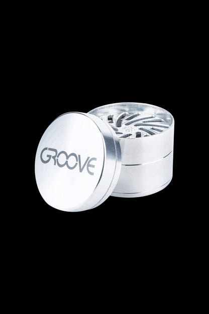 Silver cannabis grinder with “GROOVE” logo.