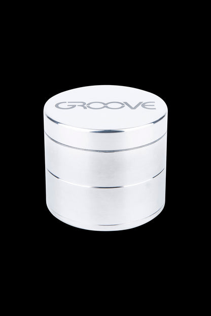 Silver four-layer cannabis grinder with “GROOVE” logo.