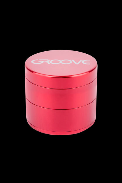 Red four-layer cannabis grinder with "GROOVE" logo.