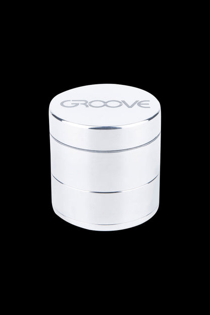 Silver four-layer herb grinder with "GROOVE" logo on top.