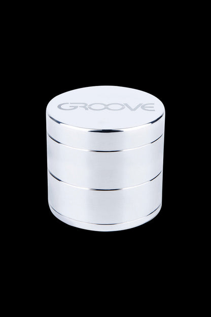 Silver four-layer cannabis grinder with “GROOVE” engraved on top.