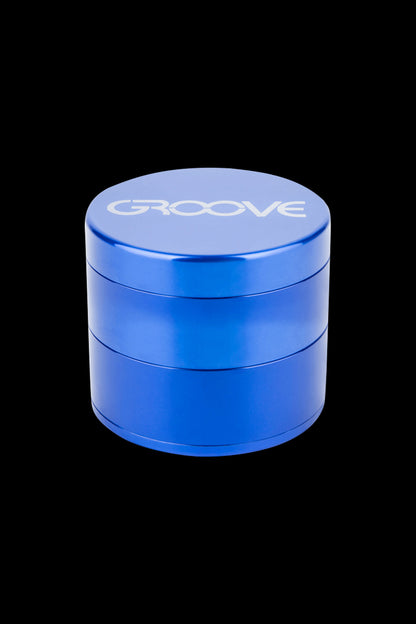 Blue four-piece metal grinder with "GROOVE" logo.