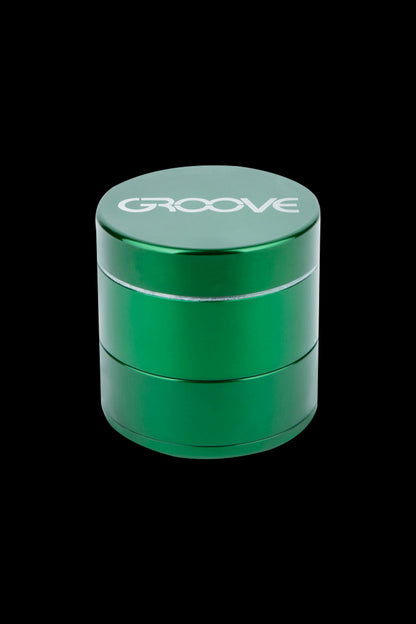 Green four-piece cannabis grinder with “GROOVE” logo.