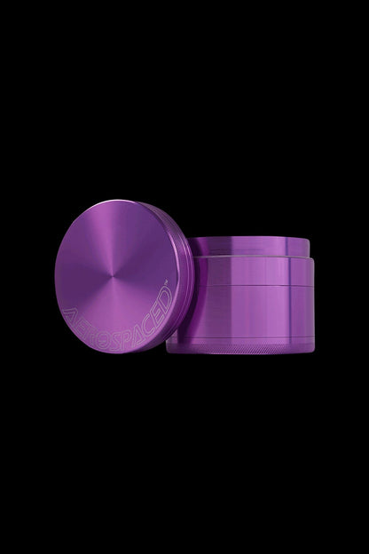 Purple four-piece metal grinder for cannabis.
