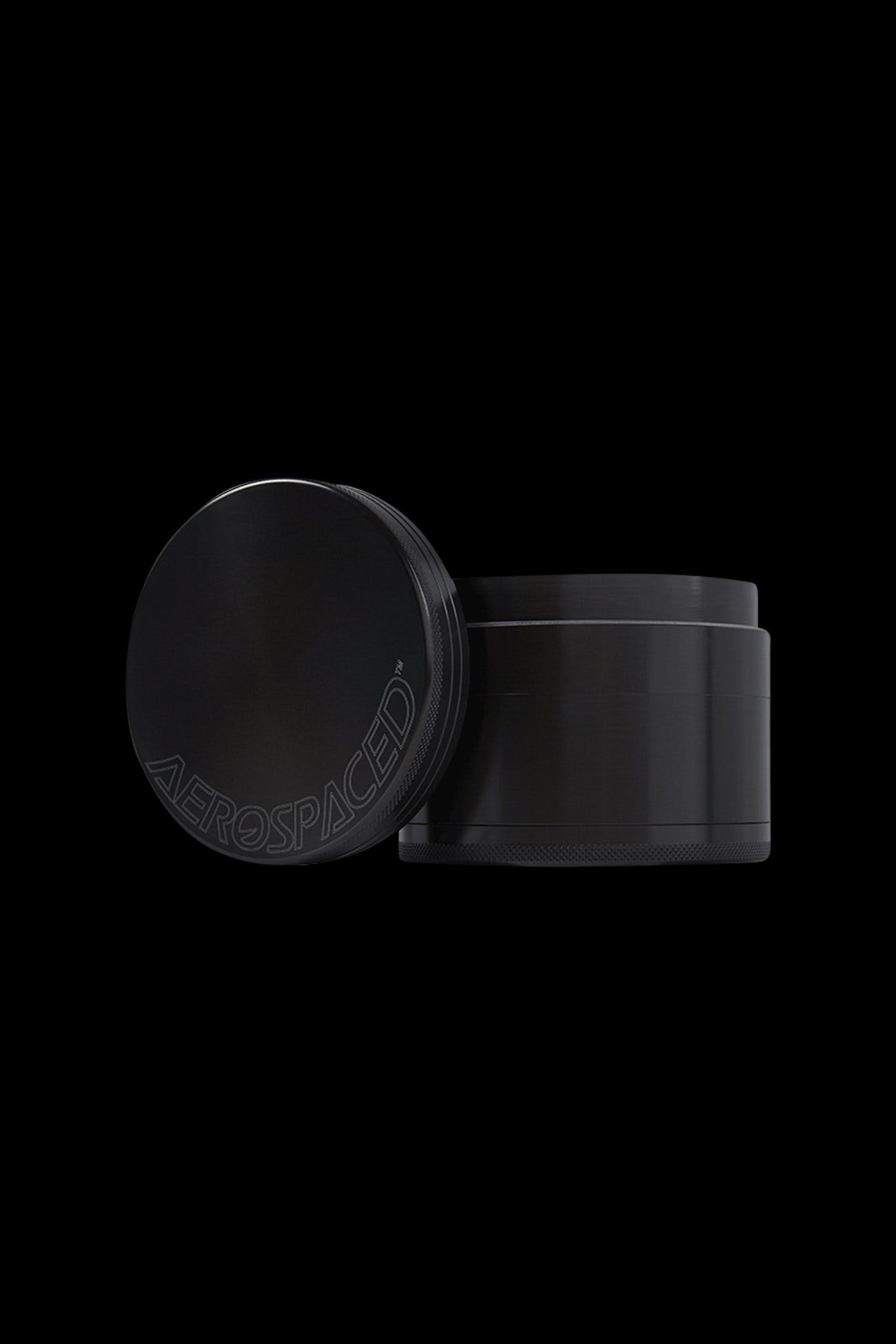 Black cannabis grinder with “AEROSPACED” logo on lid.