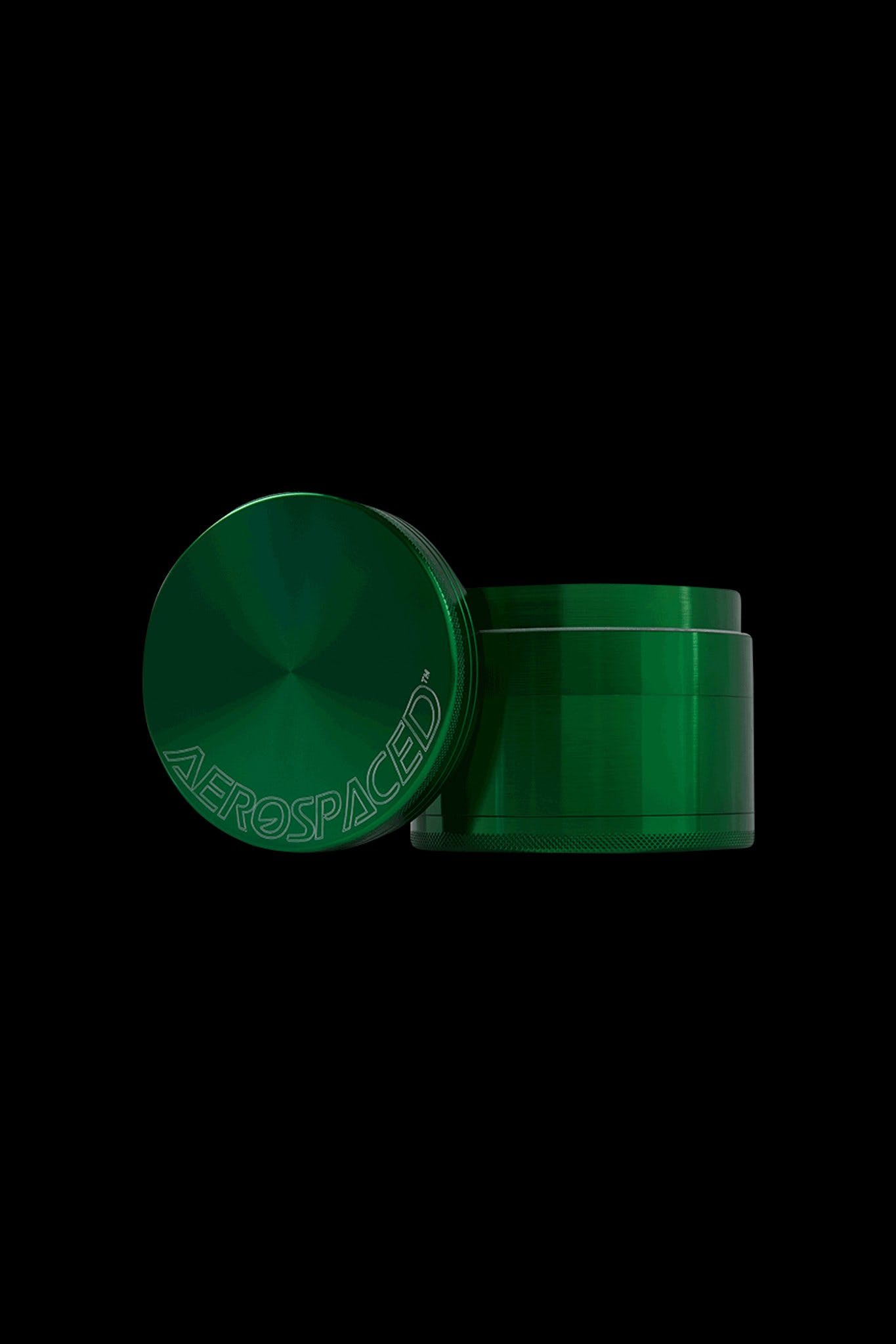 Green cannabis grinder with “Aerospace” branding.