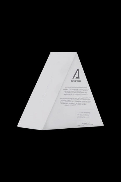 White, triangular cannabis packaging with “AEROSPACED” branding and French/English text.