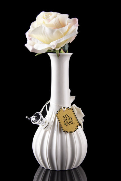 Elegant white glass vase with a cannabis bud displayed inside, tagged “My Bud Vase” and reflecting on a black surface.