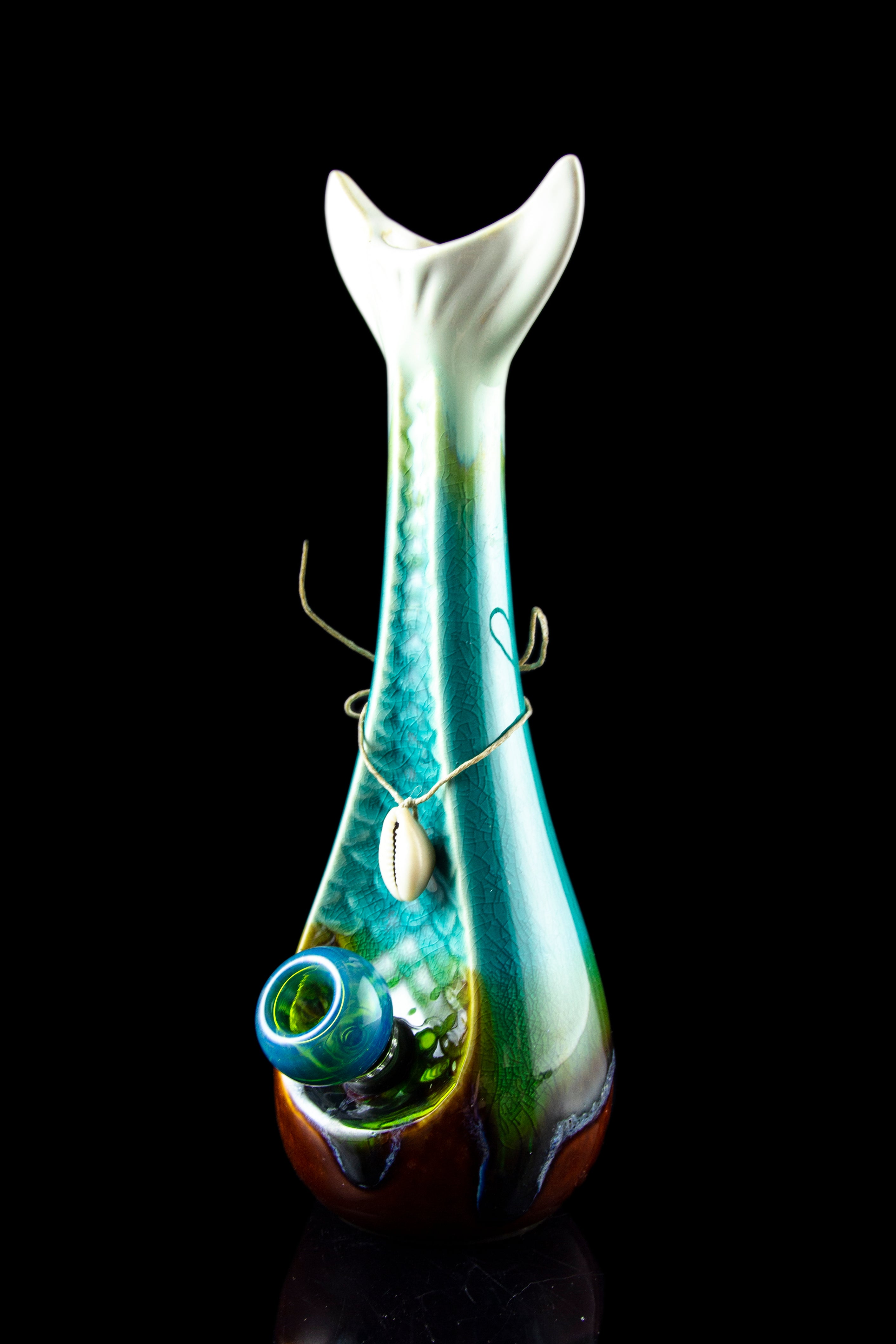 Iridescent glass water pipe with a teal and green swirl pattern, displayed against a black background.