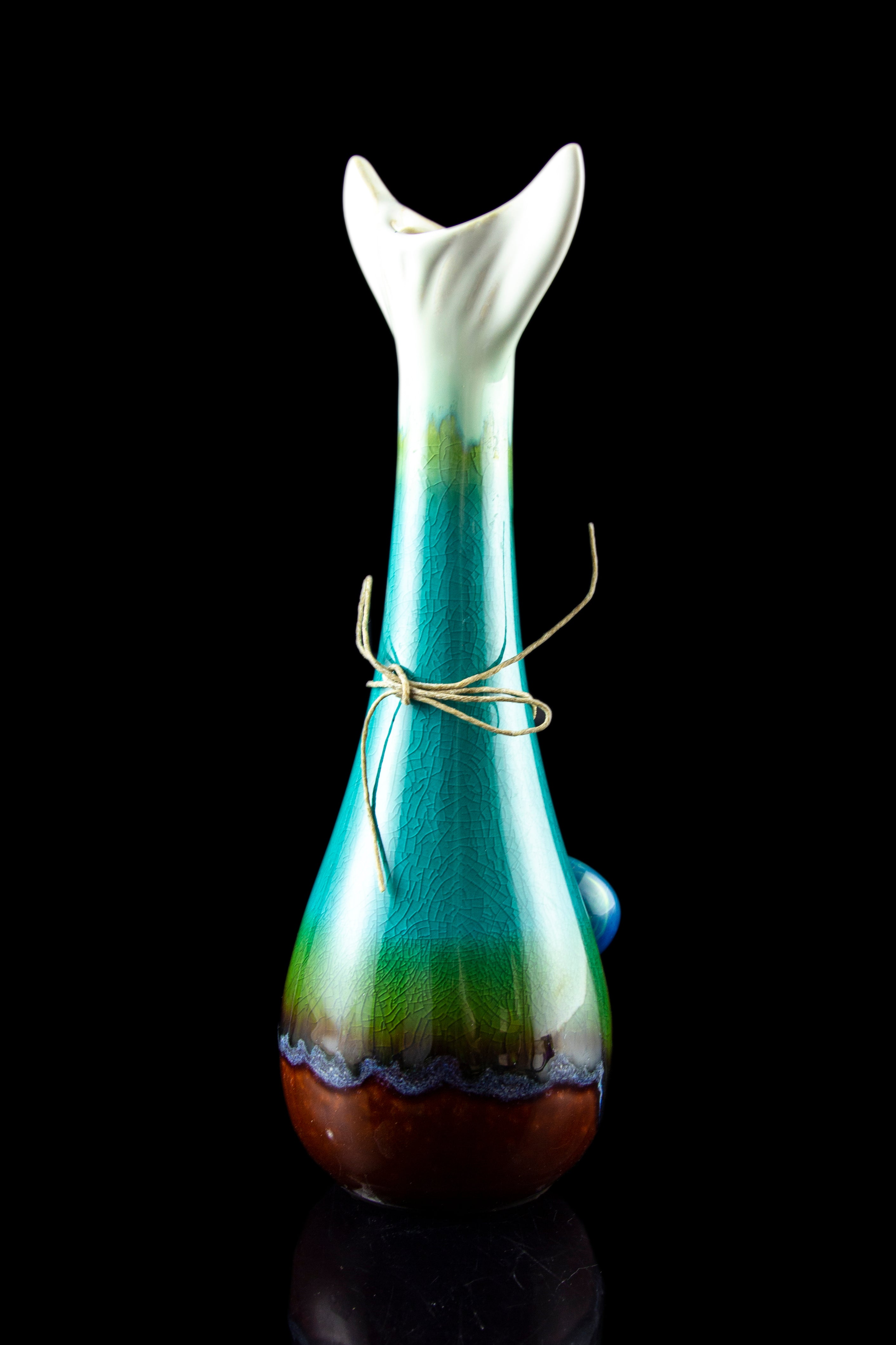 Hand-blown glass bubbler with teal and brown marbling, tied with twine.