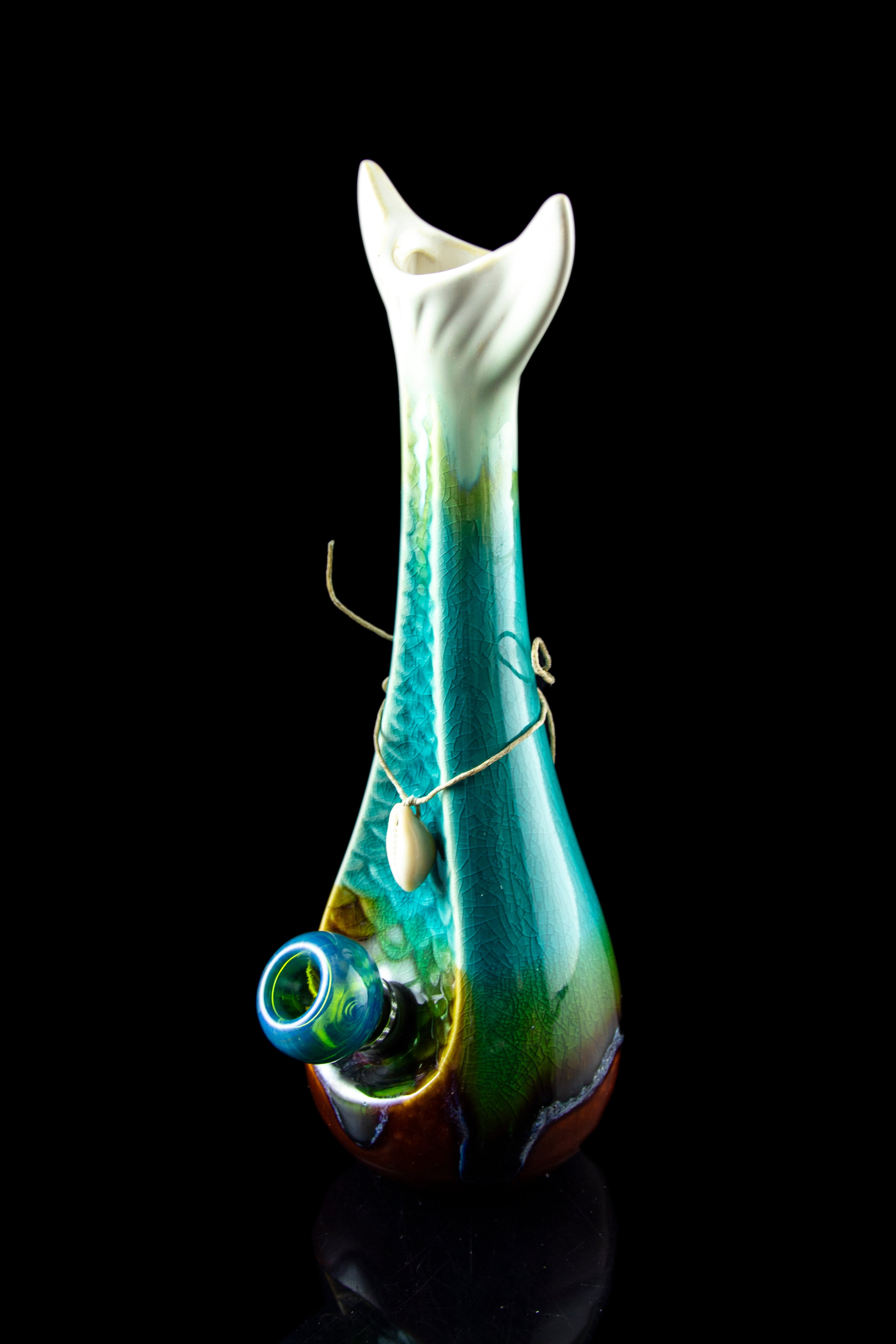 A vibrant green and blue glass water pipe with intricate swirling patterns, displayed against a black background.