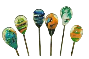 Row of six colorful Handblown Glass Hair Pin / Poker heads seen front-on, each teardrop glass head showing swirled blue, green, yellow and orange patterns against a white background.