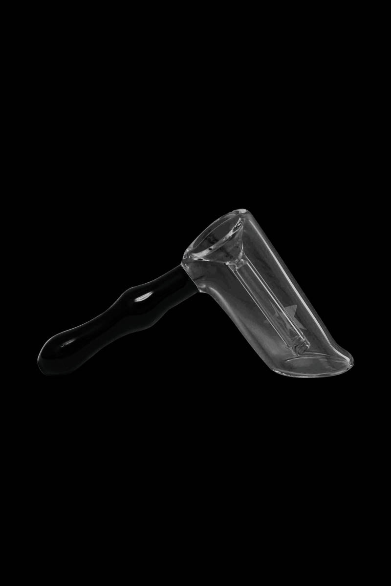 Angled close-up of the Famous X Straight Hammer Bubbler Pipe showing its clear glass chamber and black handle against a black background