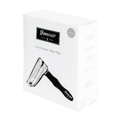 Angled close-up of the Famous X Straight Hammer Bubbler Pipe box showing the black logo plate and partial glass pipe image.