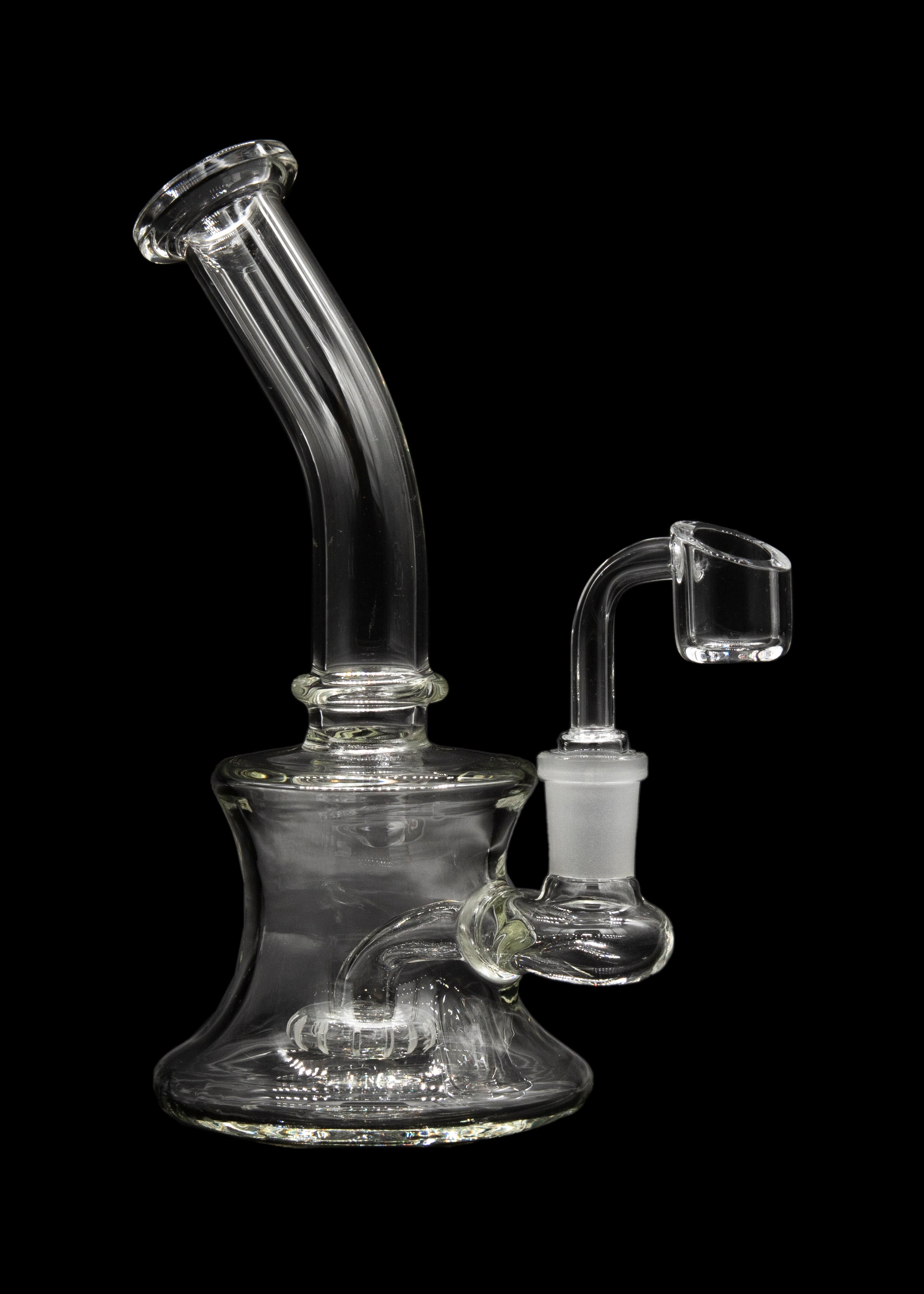 Clear glass water pipe (bubbler) with a quartz oil rig attachment, isolated on black.