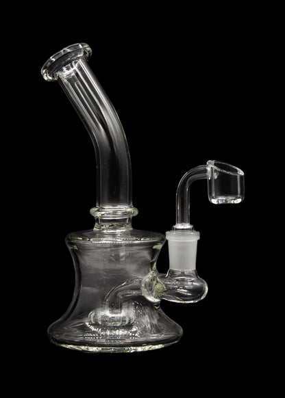 Clear glass water pipe (bubbler) with a quartz oil rig attachment, isolated on black.