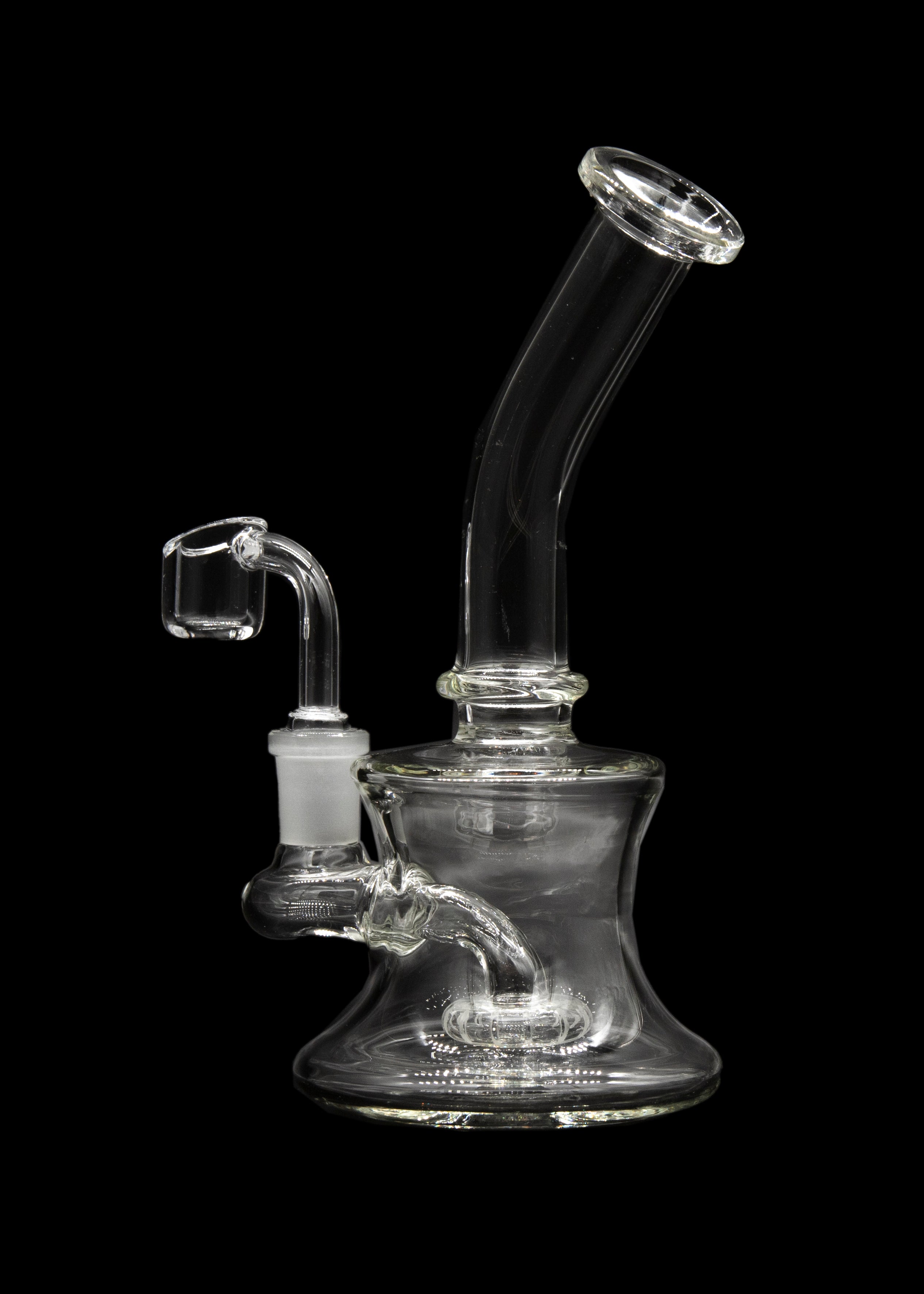 Clear glass dab rig with a quartz banger, isolated on a black background.