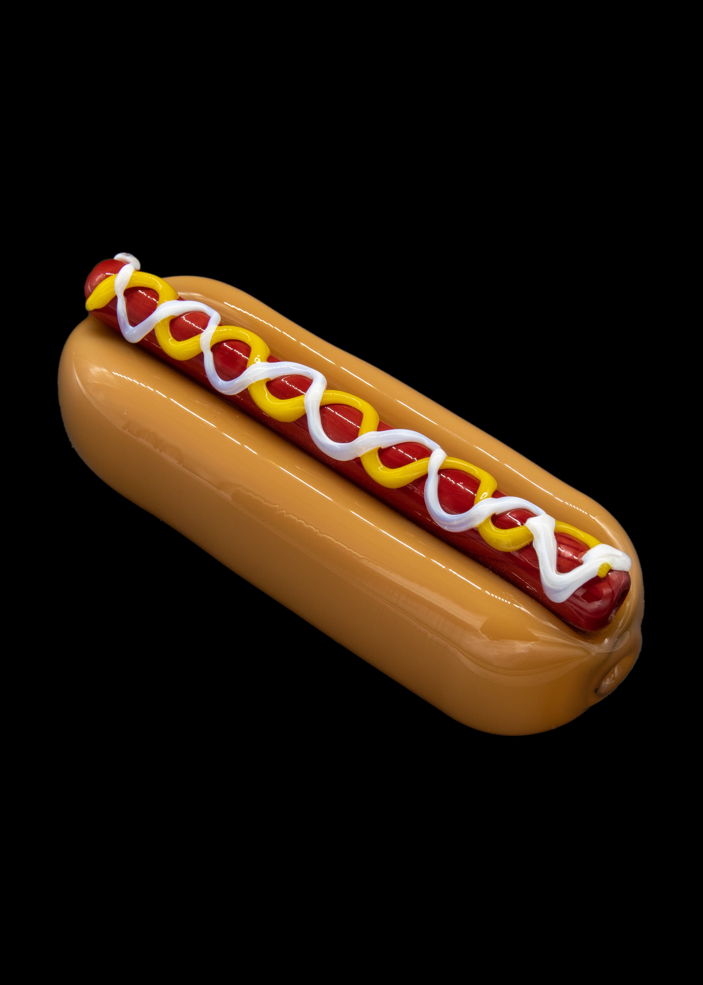Glass pipe shaped like a hot dog with mustard and ketchup.