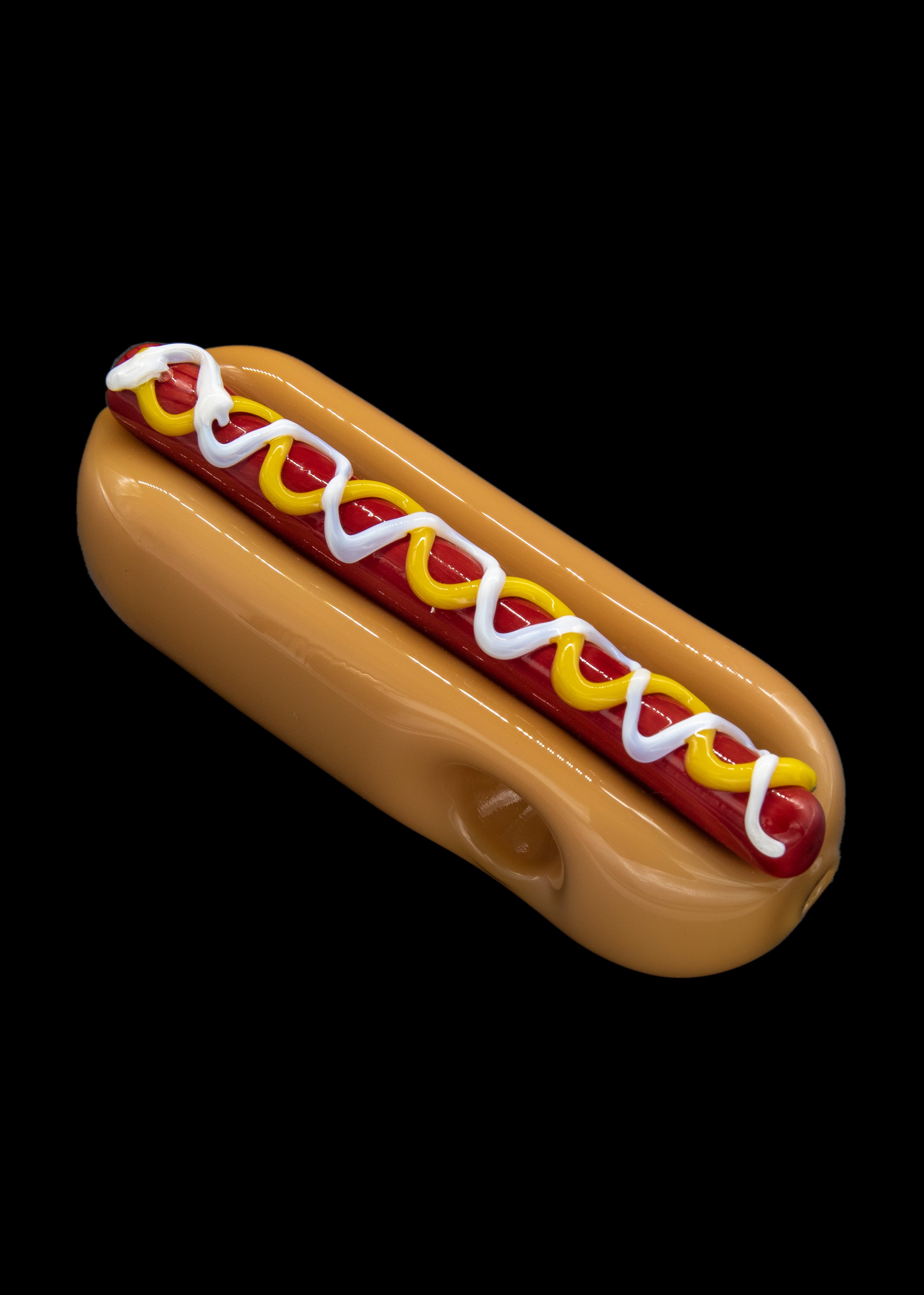 Glass pipe shaped like a hot dog with mustard and ketchup.
