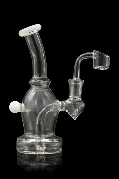Clear glass dab rig with a quartz banger, studio shot on a black reflective surface.
