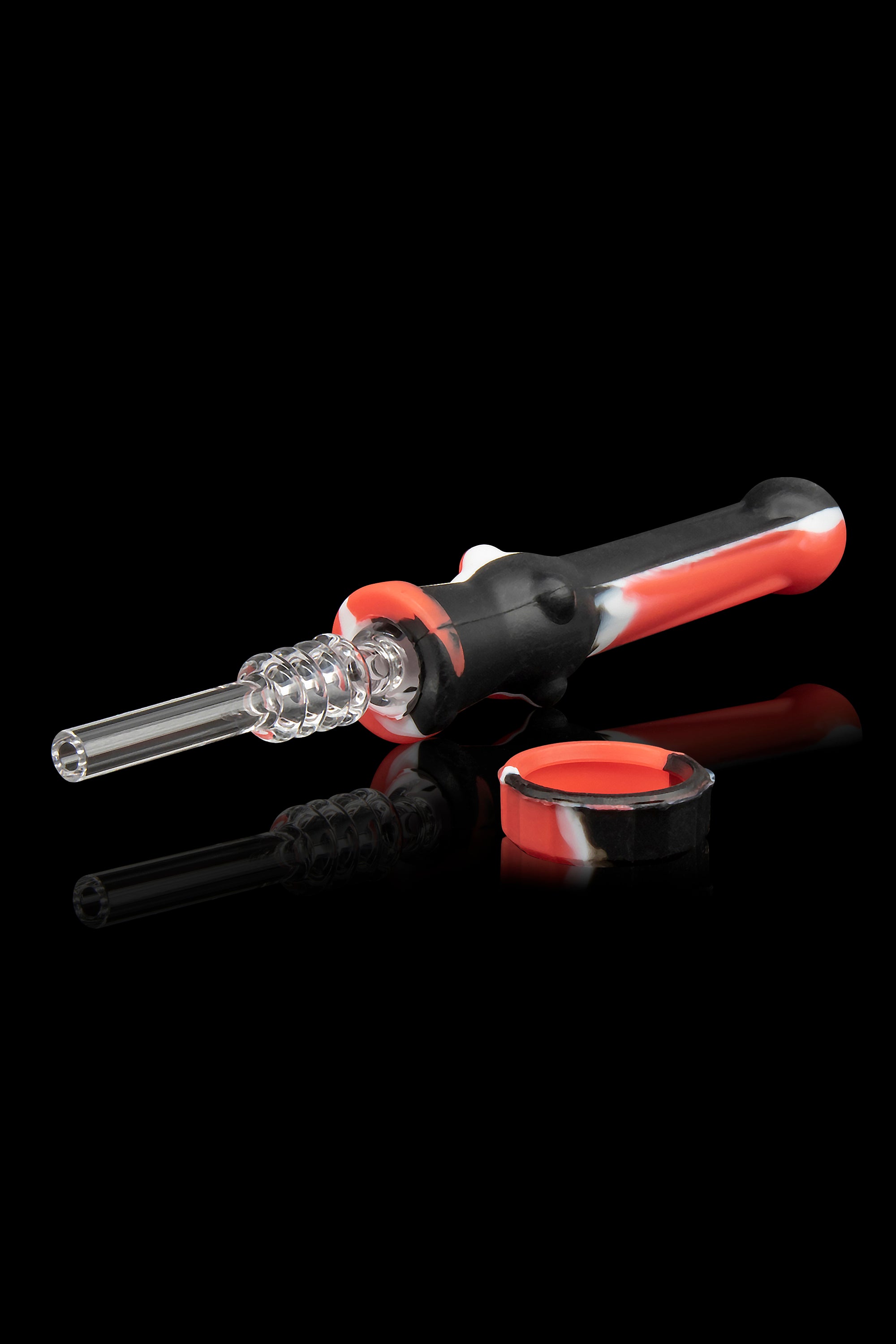 Dab tool kit with quartz tip, silicone body, and collection dish on a reflective surface.