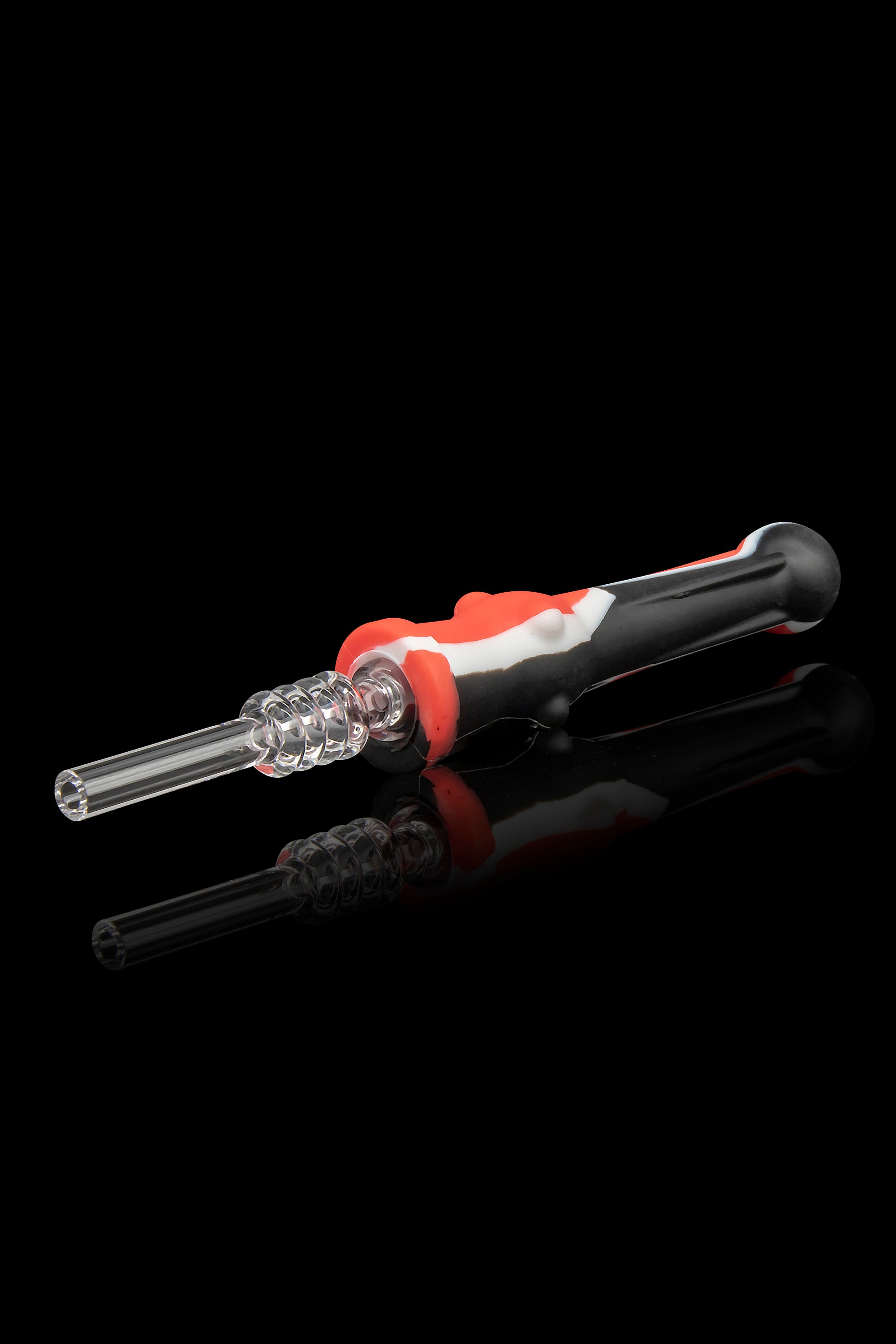 Dab tool with a clear glass tip and red silicone handle, reflecting on a black surface.