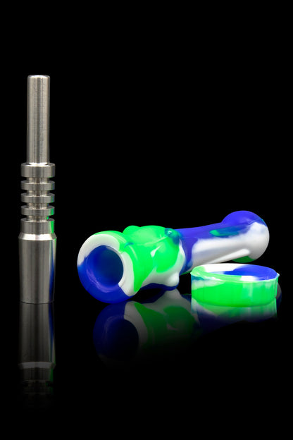 Dab rig accessories: a titanium nail and colorful silicone carb cap and dish, isolated on a black reflective surface.