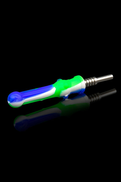 Colorful silicone dab tool with titanium tip, reflecting on a black surface.
