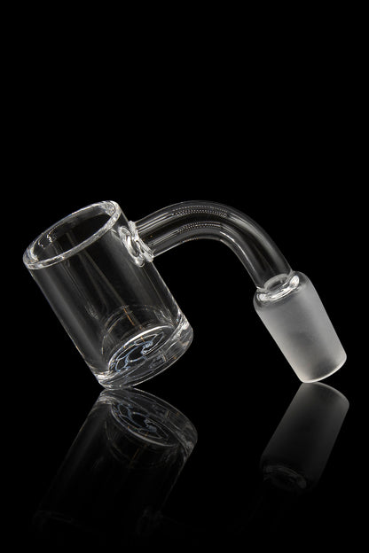 Clear glass dab rig nail with a bent neck, reflecting on a black surface.