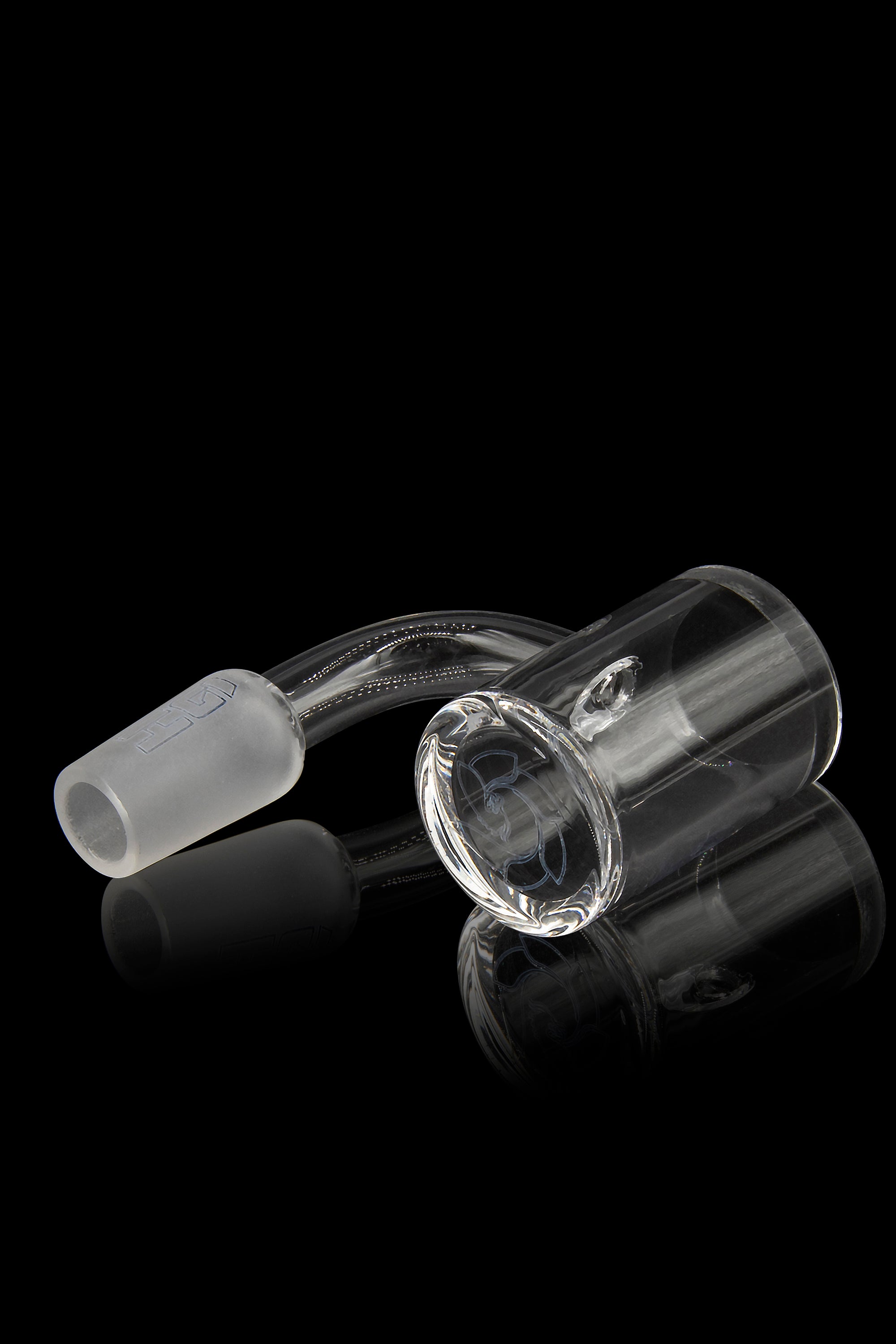 Clear glass cannabis oil rig with a bent neck and spherical attachment, displayed on a reflective surface against a black background.