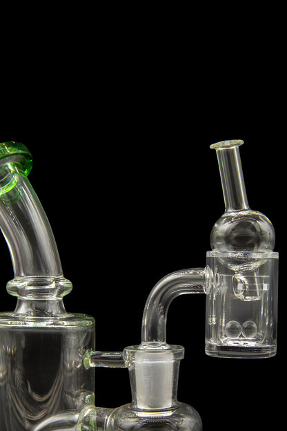 Clear glass cannabis water pipes and dab rig with green accents, isolated on a black background.