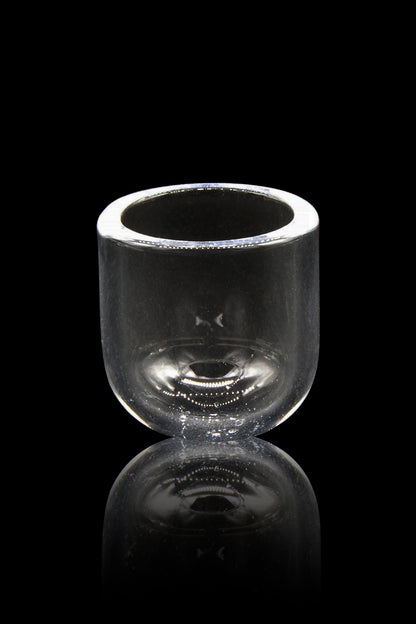 Clear glass bubbler with a reflective surface, isolated on black.