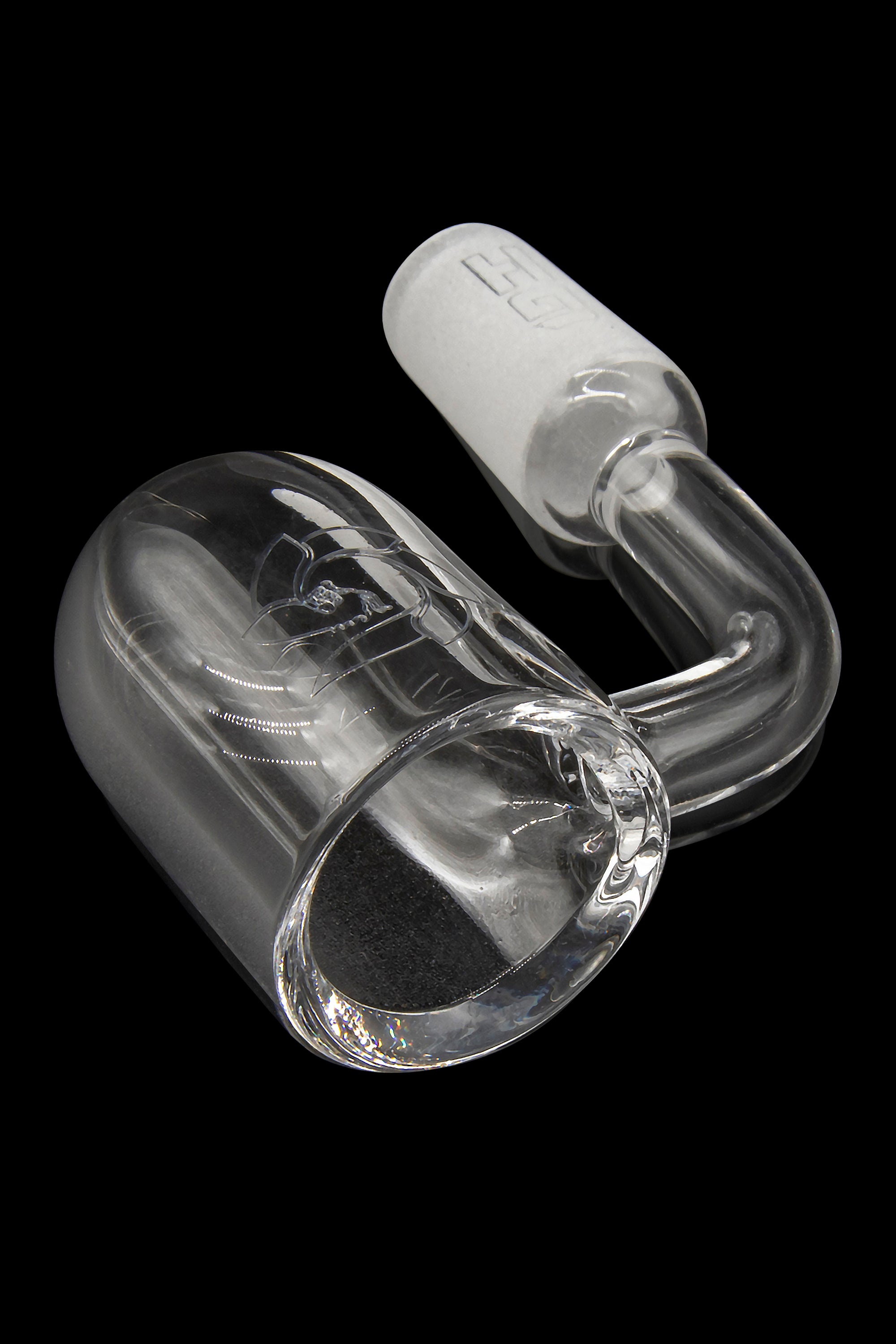 Clear glass dab rig with intricate looping design, isolated on black.