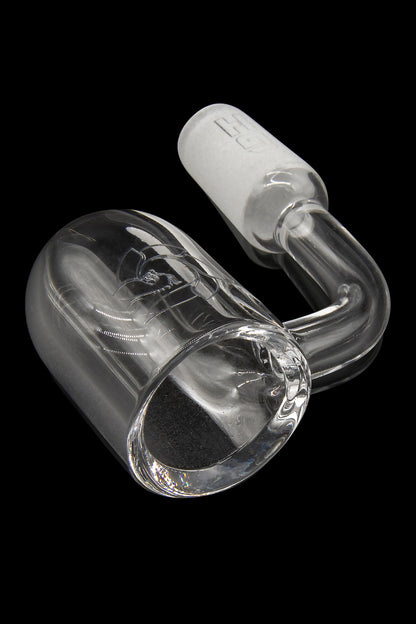 Clear glass dab rig with intricate looping design, isolated on black.