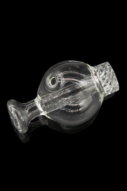 Clear glass bubbler for smoking cannabis, isolated on a black background.